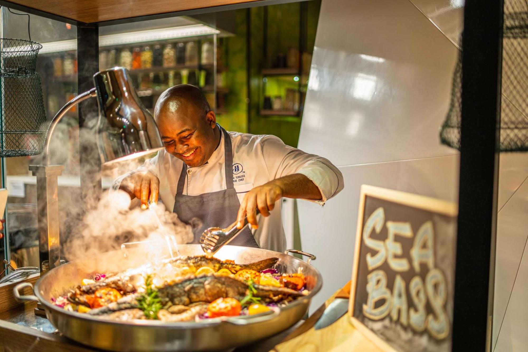 Hotel Hilton Bahrain Manama Zewnętrze zdjęcie Chef preparing food at the Sea Bass restaurant